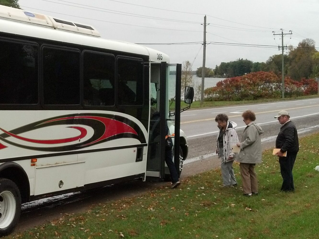 group of people boarding a bus.
